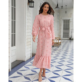 Fashionable women's dress with long sleeves and a large fluffy pom-pom detail, made from chiffon fabric