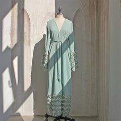 Stylish Muslim women's long robe in a solid color with ruffled sleeves, featuring a fashionable blue hue