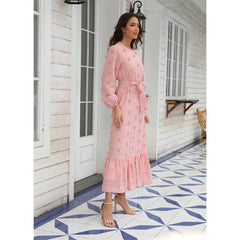 Fashionable women's dress with long sleeves and a large fluffy pom-pom detail, made from chiffon fabric