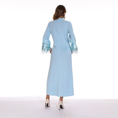 Elegant solid color women's long dress with round neckline, embellished with sparkling sequins and featuring feathered sleeves