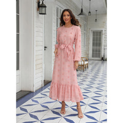 Fashionable women's dress with long sleeves and a large fluffy pom-pom detail, made from chiffon fabric