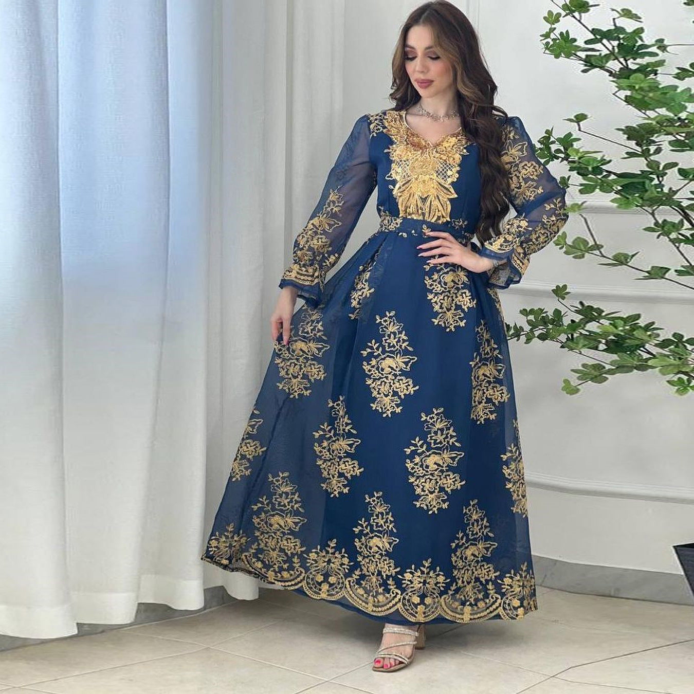 Jalabiya Embrace elegance with an embroidered jalabiya adorned with appliques | a floor-length evening robe | a waist-cinching belt | and an aura of grace