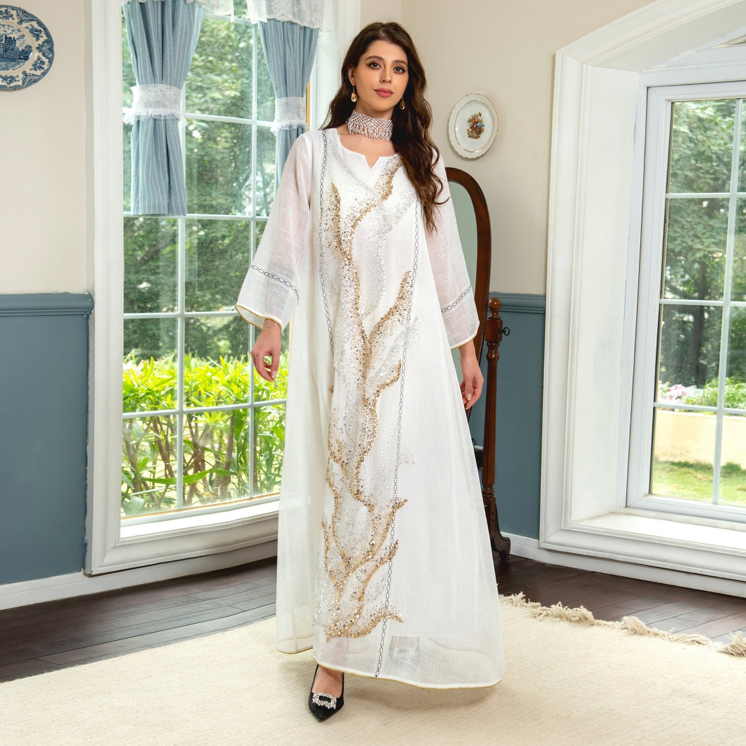 Indulge in the exquisite elegance of a white mesh jalabiya, adorned with beadwork embroidery, offering a lightweight and luxurious comfort