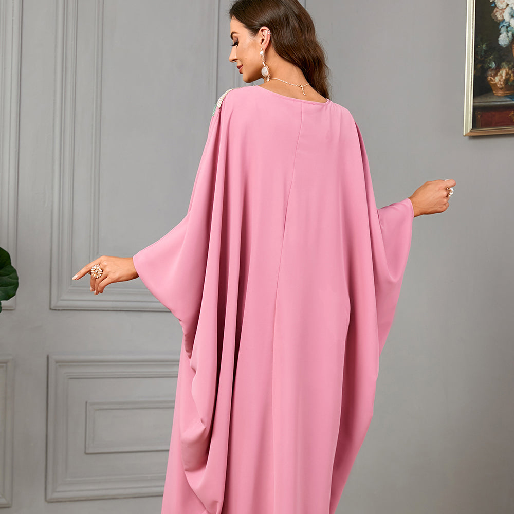 Enjoy the comfort of a jalabiya , adorned with lace appliques, featuring a fringe-trimmed neckline , and relaxed batwing sleeves