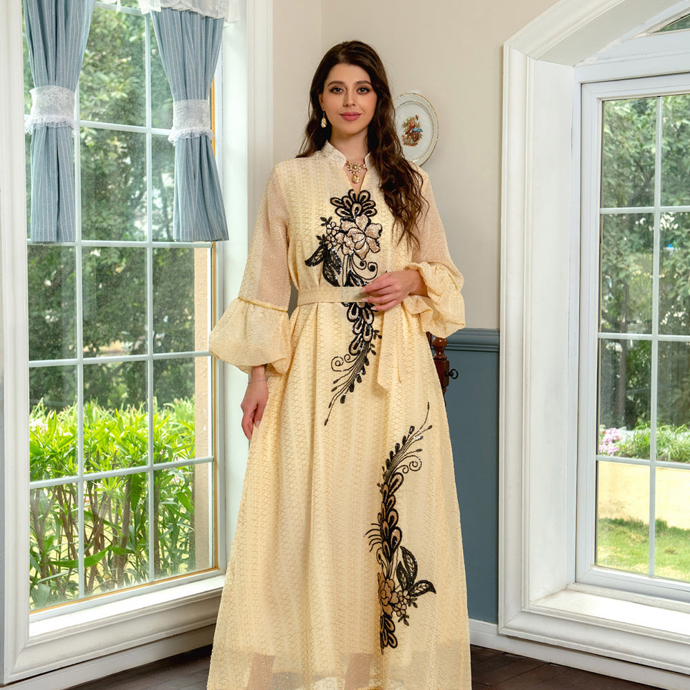 Jalabiya Elevate your style with a fashionable and avant-garde jalabiya | featuring embroidered appliques | bell sleeves | a waist-cinching tie | and a contemporary edge