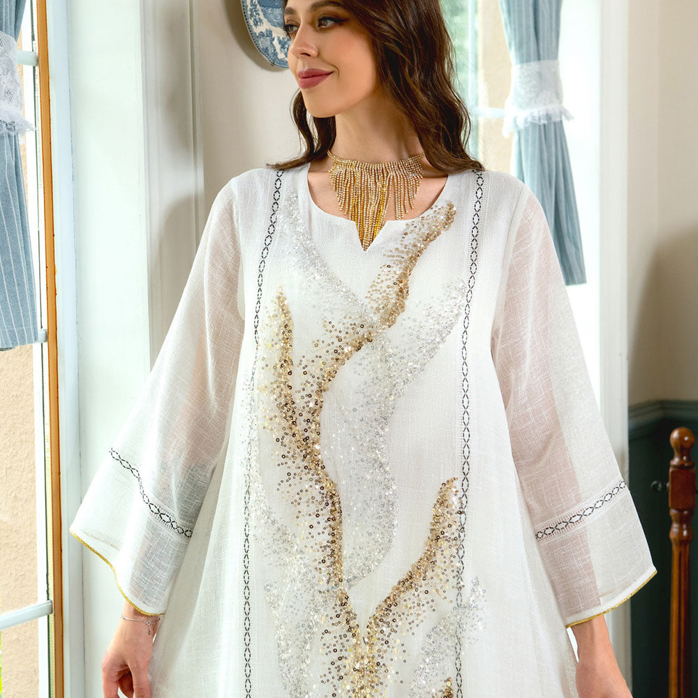 Indulge in the exquisite elegance of a white mesh jalabiya, adorned with beadwork embroidery, offering a lightweight and luxurious comfort