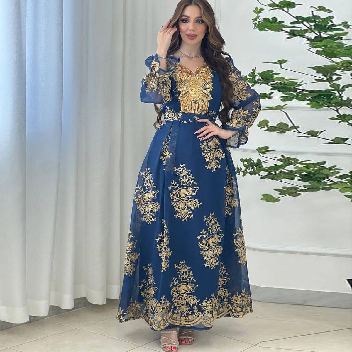 Jalabiya Embrace elegance with an embroidered jalabiya adorned with appliques | a floor-length evening robe | a waist-cinching belt | and an aura of grace