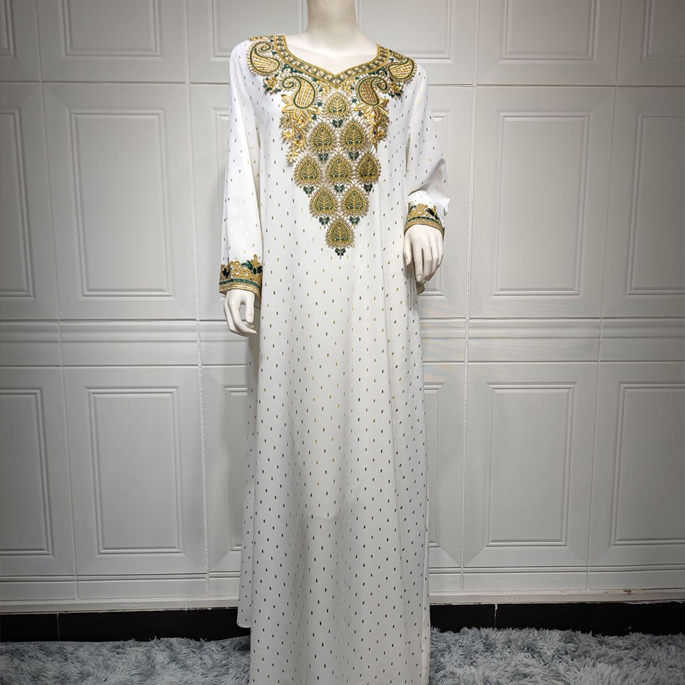 Jalabiya Discover the essence of understated elegance with a jalabiya | adorned with delicate lace | gold foil accents | embroidered appliques | and a minimalist allure