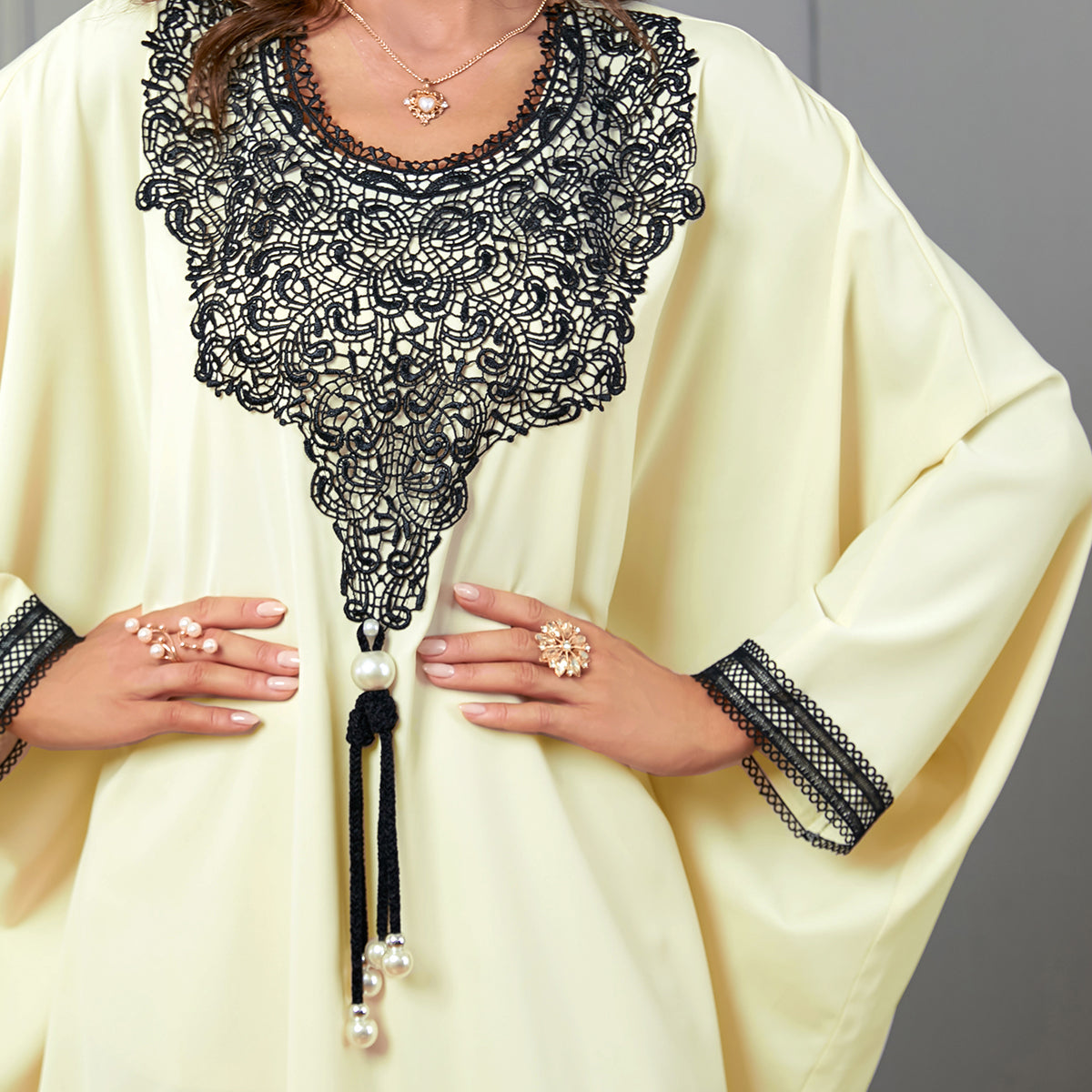 Embrace the charm of a jalabiya with embroidered appliques ,Delicate lace trim on the cuffs ,Tassel accents , Loose-fitting batwing sleeves