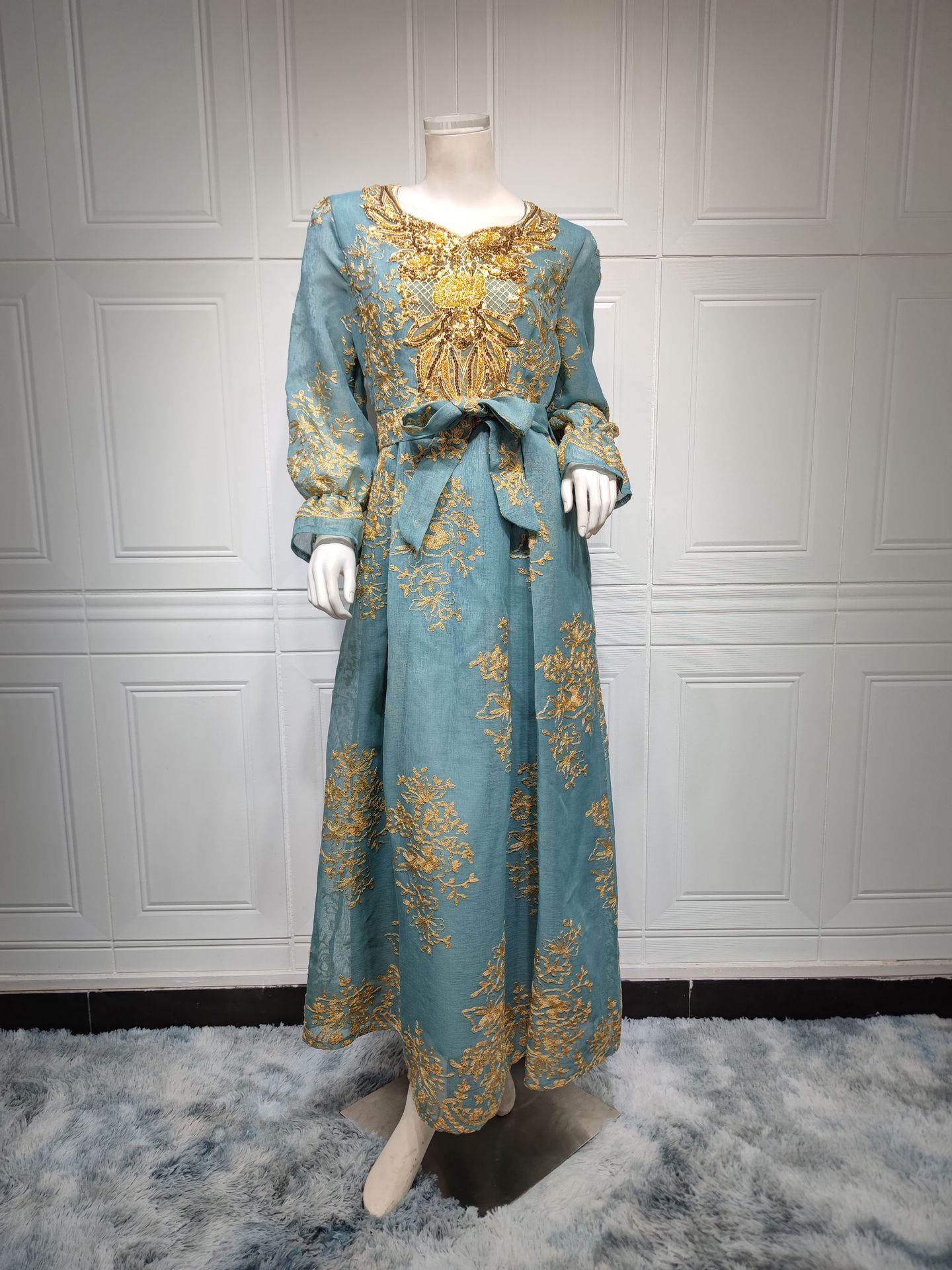 Jalabiya Embrace elegance with an embroidered jalabiya adorned with appliques | a floor-length evening robe | a waist-cinching belt | and an aura of grace