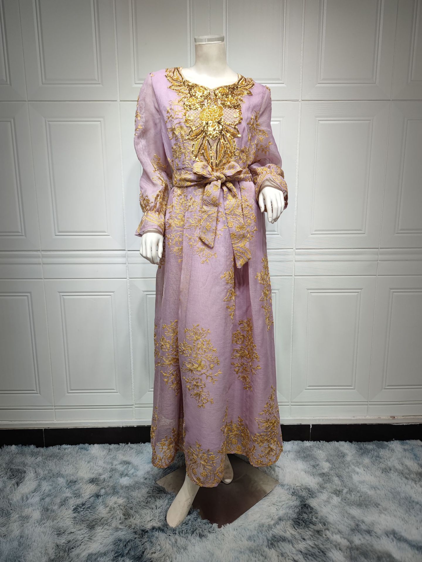 Jalabiya Embrace elegance with an embroidered jalabiya adorned with appliques | a floor-length evening robe | a waist-cinching belt | and an aura of grace